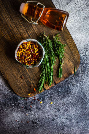 Organic food concept with herbs and spices on cutting boardの写真素材