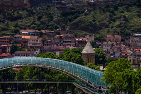 28 May 2019, TBILISI, GEORGIA: Famous view to carving balconies of Kala area and glass Peace bridge on Mtkvari river  in Tbilisi's downtownのeditorial素材