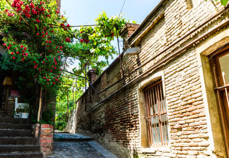 28 May 2019, TBILISI, GEORGIA: View to the streets of Old Town of Tbilisi with traditional wooden carving balconies and stone roadsのeditorial素材