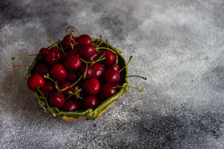 Sweet organic cherries on stone background with copy spaceの写真素材