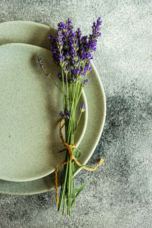 Summer table setting with fresh lavender flowers on concrete background with copy spaceの写真素材