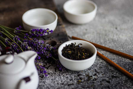 Asian style tea set with lavender flowers on rustic background with copy spaceの写真素材