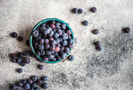 Organic food concept with ripe blueberry on rusty stone backgroundの写真素材