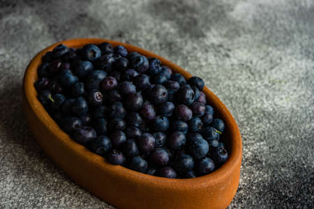 Organic food concept with ripe blueberry on rusty stone backgroundの写真素材