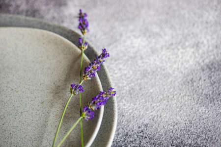 Summer table setting with fresh lavender flowers on concrete background with copy spaceの写真素材