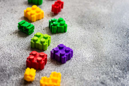Kid concept with different colors toy blocks on concrete background with copy spaceの写真素材