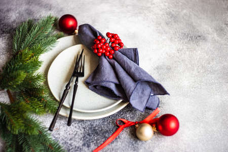Rustic table setting for holiday Christmas dinner on grey stone background with copy spaceの写真素材