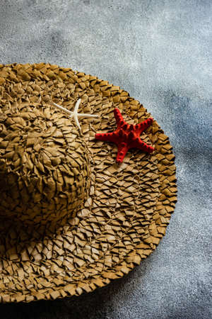 Wide straw hat on rustic background as a holiday conceptの写真素材