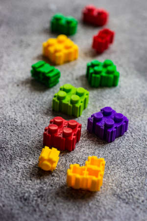 Kid concept with different colors toy blocks on concrete background with copy spaceの写真素材