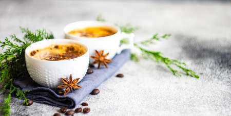 Cup of coffee and Christmas decor on rusty stone backgtound  with copy spaceの写真素材