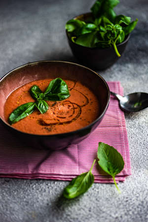 Traditional spanish tomato cream soup Gazpacho in ceramic bowl on rusty stone background with copy spaceの写真素材