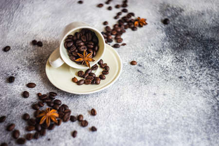 Ceramic cup and coffee beans on stone background with copy space as a coffee conceptの写真素材