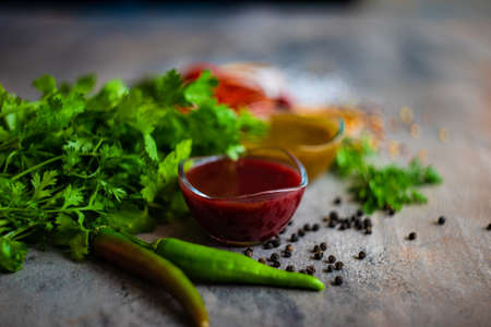 Traditional georgian sauces like tomato satsebeli, yellow and red tkemali with ingredients on stone background with copy spaceの写真素材
