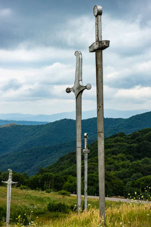 20 JULY 2019, GEORGIA, TBILISI, Famous Didgori battle monument with giant swards and sculptures of soldiers close to Tbilisi in Caucasus mountain rangeのeditorial素材
