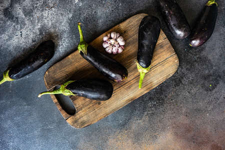 Organic food concept with eggplants on stone background with copy spaceの写真素材