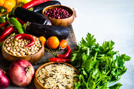 Organic food concept with variety of fresh vegetables and cereals on stone background with copy spaceの写真素材