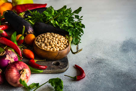 Organic food concept with variety of fresh vegetables and cereals on stone background with copy spaceの写真素材