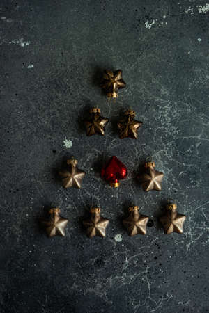 Christmas festive concept xmas tree shaped with balls on rustic background with copy space