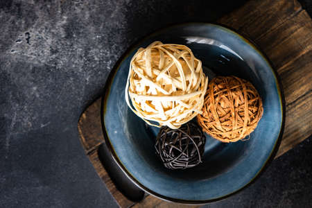 Rustic table setting with balls in ceramic bowl on stone copy space