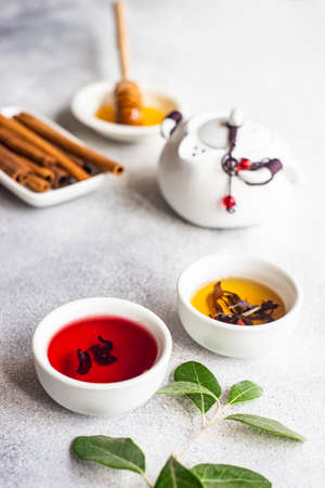 Floral tea concept with tea pot and cups on stone background with copy spaceの写真素材