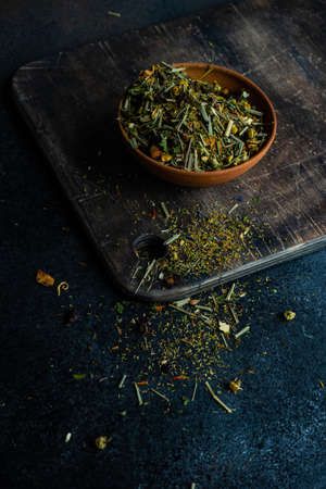 Floral tea concept with tea pot and cups on stone background with copy space