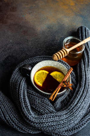 Mulled tea with lemon and spices on stone table with copy spaceの写真素材