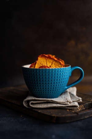 Traditional georgian dessert with dried persimmon fruits on dark concrete background
