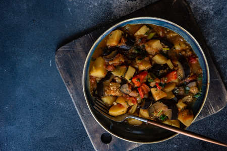 Popular georgian summer and autumnal dish Ajapsandali with vegetables on stone background with copy spaceの写真素材