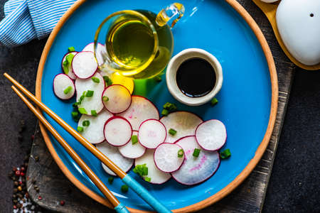 Organic radish salad in asian style on stone background with copy spaceの写真素材