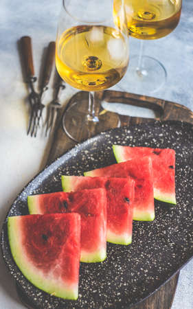 Organic watermelon slice on a plate served on stone background with copy spaceの写真素材