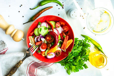 Healthy food concept with fresh organic vegetables salad on stone background with copy spaceの写真素材