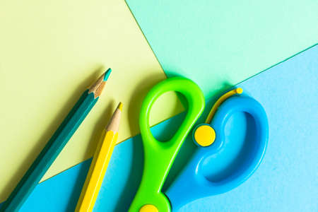 Studing concept with blue, green and yellow pastel paper as a backgroundの写真素材