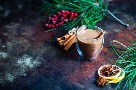 Glass of coffee with milk and spices on stone background with copy spaceの写真素材
