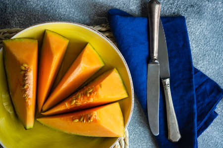 Organic ripe melon fruit on concrete background with copy spaceの写真素材