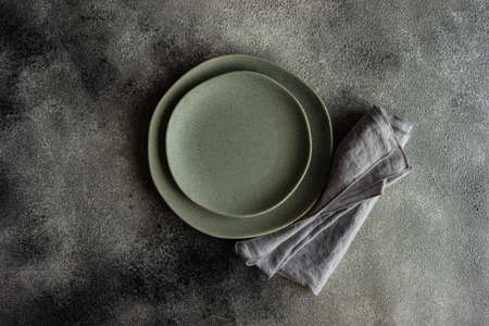 Cutlery set with empty plates on stone background with copy spaceの写真素材
