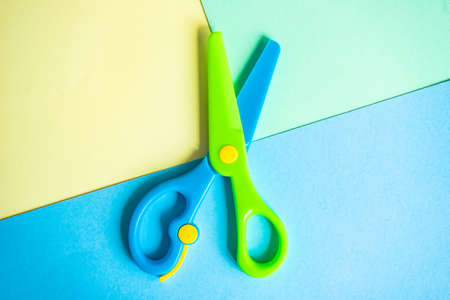 Studing concept with blue, green and yellow pastel paper as a backgroundの写真素材