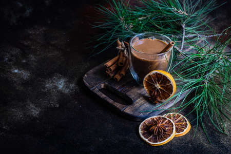Glass of coffee with milk and spices on stone background with copy spaceの写真素材