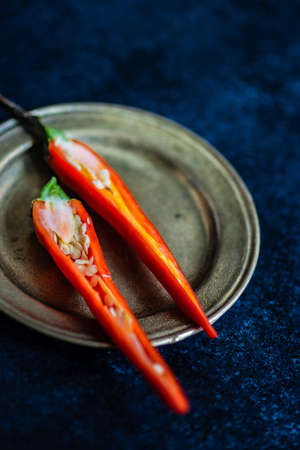 Red hot chille pepper on rustic background with copy space
