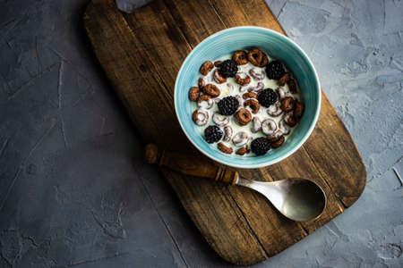 Traditional breakfast with chocolate cornflakes, yogurt and honey on rustic backgroundの写真素材