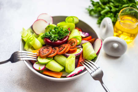 Healthy food concept with fresh organic vegetables salad on stone background with copy spaceの写真素材