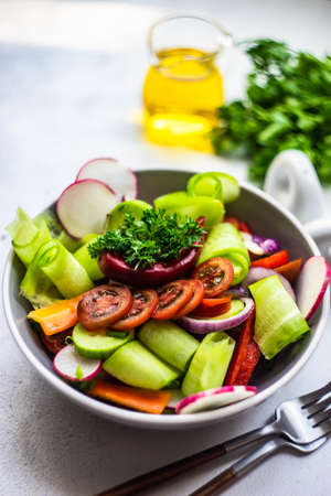 Healthy food concept with fresh organic vegetables salad on stone background with copy spaceの写真素材