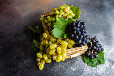 Organic food concept with variety of ripe grape on stone background with copy spaceの写真素材
