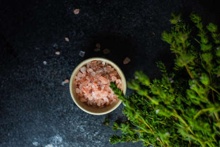Healthy food concept with himalaya salt and ombalo herb on stone background with copy space