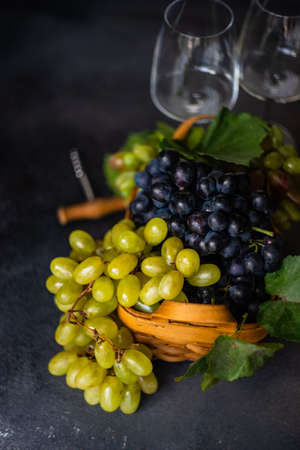 Organic food concept with variety of ripe grape on stone background with copy spaceの写真素材