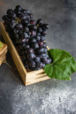 Organic food concept with variety of ripe grape on stone background with copy spaceの写真素材