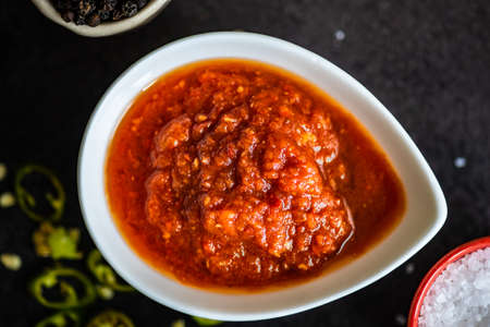 Variety of traditional georgian satsebeli sauces with kiwi, tomato and blackberry  on stone background with copy spaceの写真素材