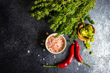 Variety of spices and herbs on stone bckground with copy spaceの写真素材