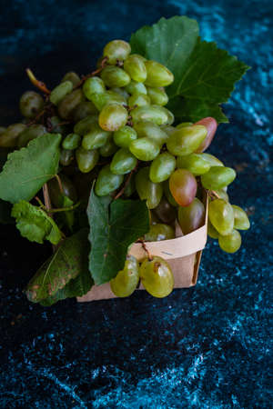 Organic food concept with variety of ripe grape on stone background with copy spaceの写真素材