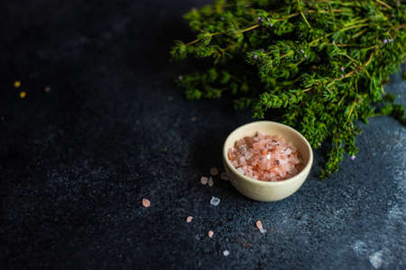 Healthy food concept with himalaya salt and ombalo herb on stone bckground with copy spaceの写真素材
