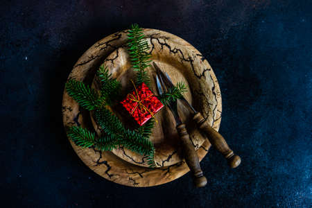 Holiday table seting with xmas tree and cutlery on stone background with copy space